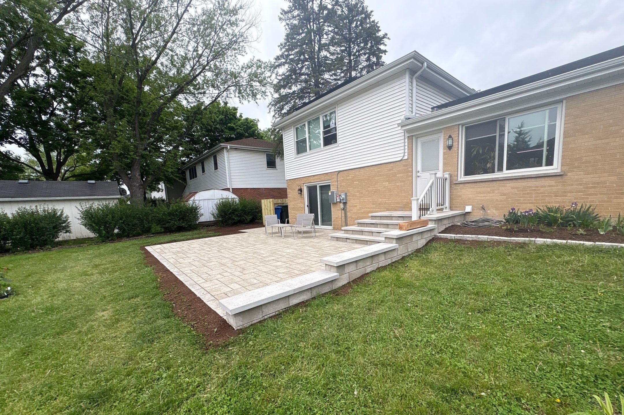 Finished paver patio with retaining wall steps installed by A&N Outdoor Services in Mount Prospect, Illinois